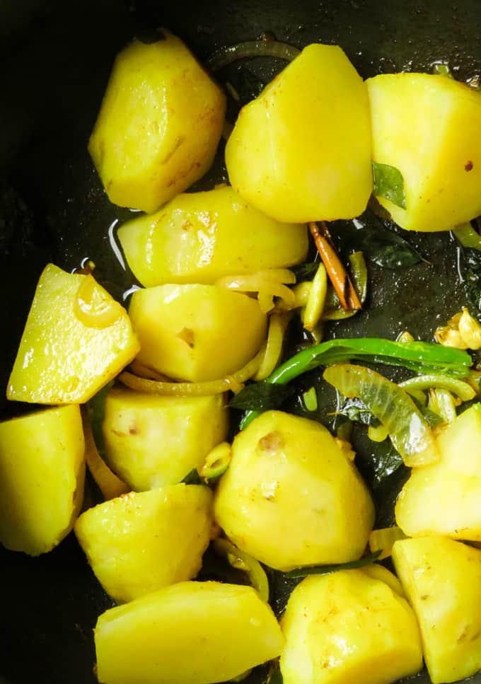 Potato added to the tempering ingredients for the curry.