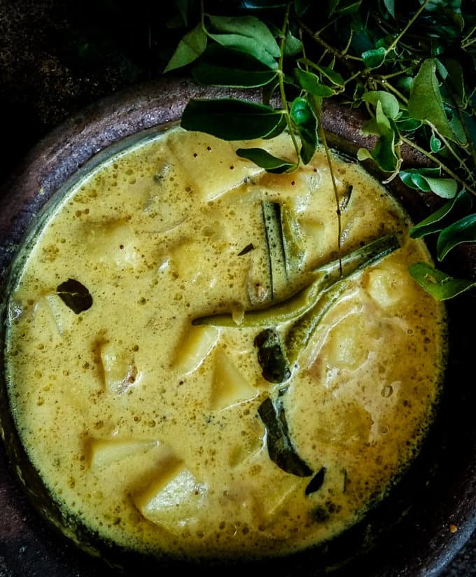 Tender Potatoes in a creamy gravy of Coconut milk in a claypot with curry leaves.