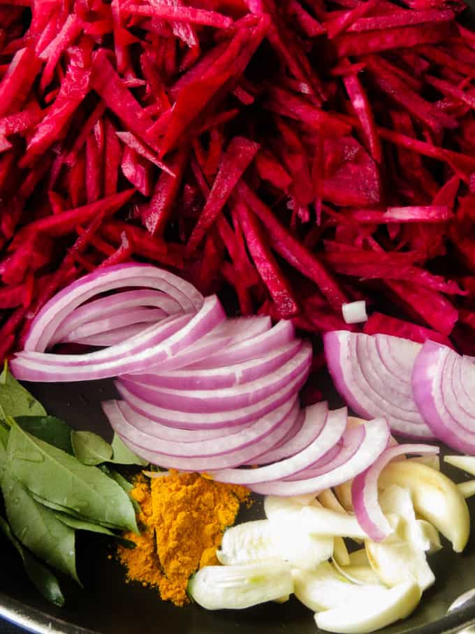 ingredients to make beetroot curry in a pan.