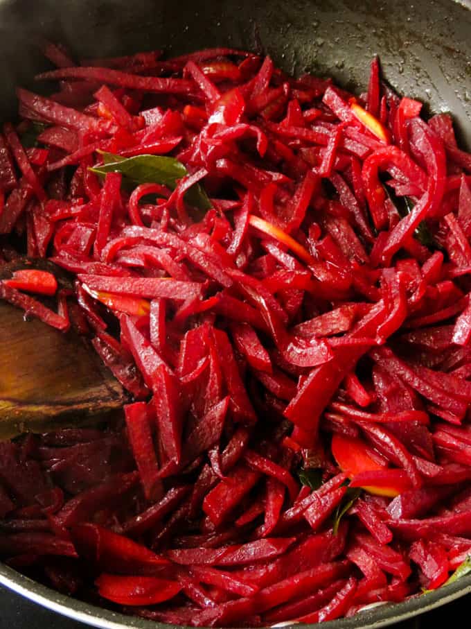 stir-frying the beetroot in a pan.