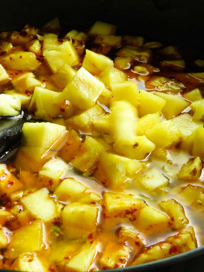 adding chopped pineapple to make the pineapple chutney.