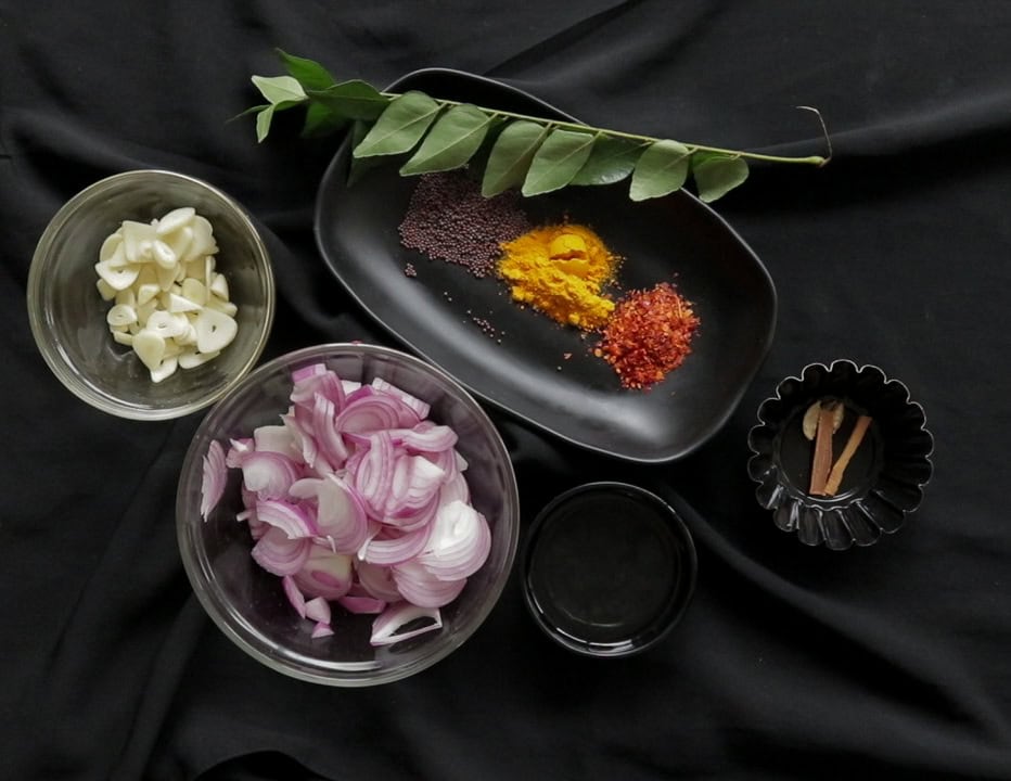 ingredients to cook the pumpkin curry pllaced in separate containers.