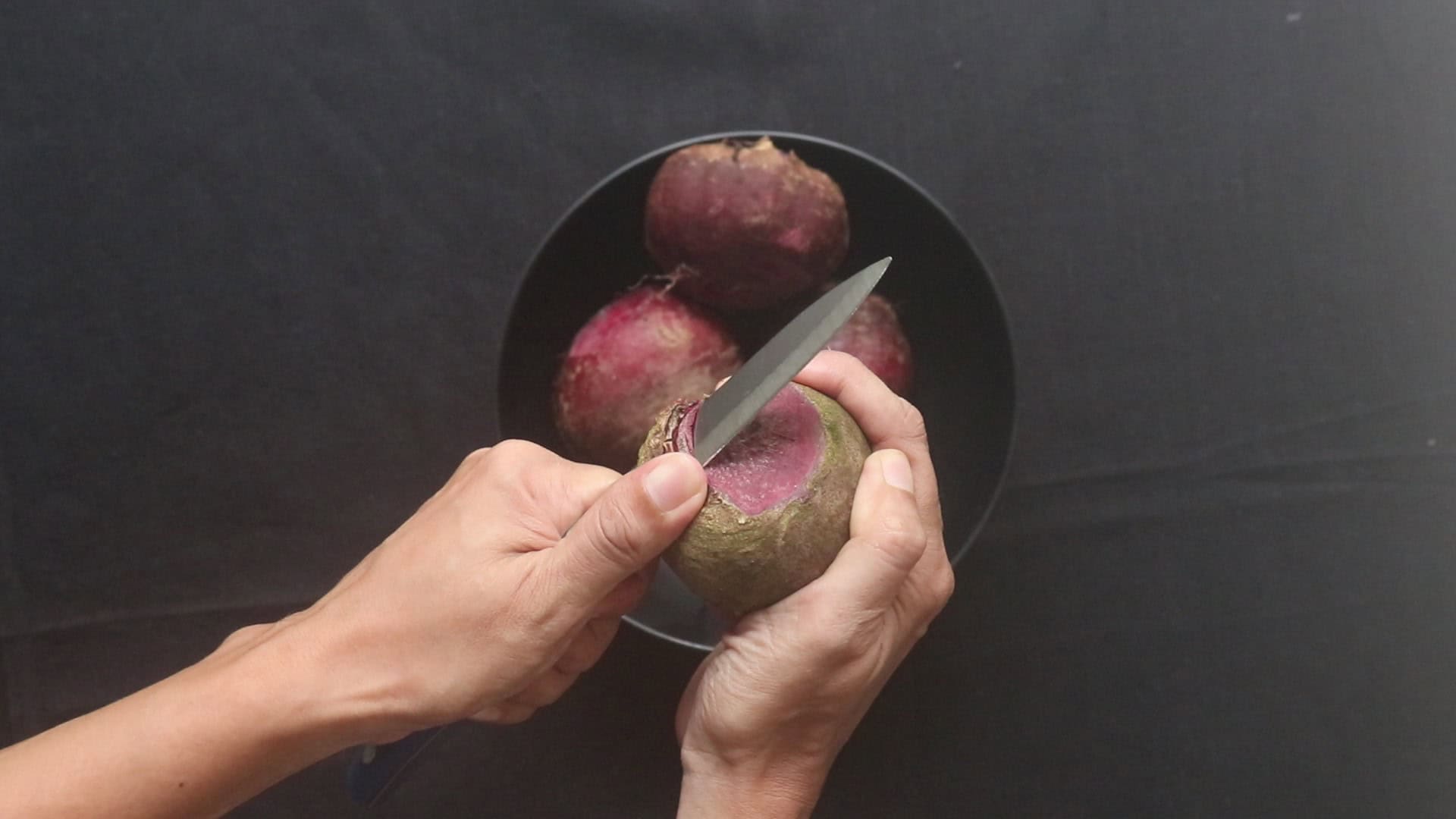 peeling the beetroot and slicing them to cook Sri Lankan beetroot curry.