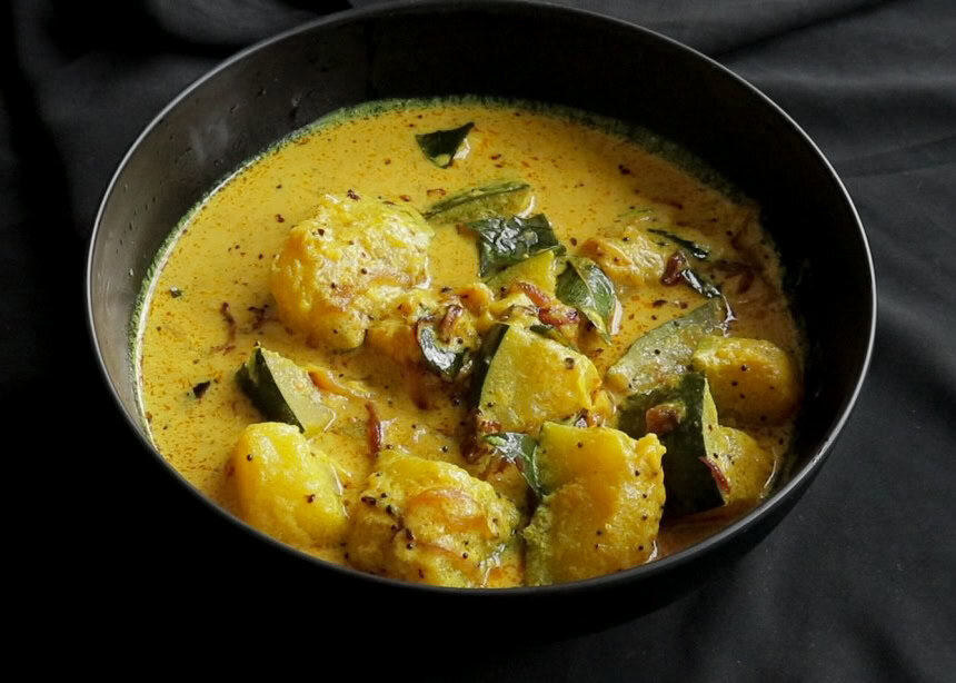 Sri lankan pumpkin curry with cubes of cooked pumpkin in spices and coconut milk.