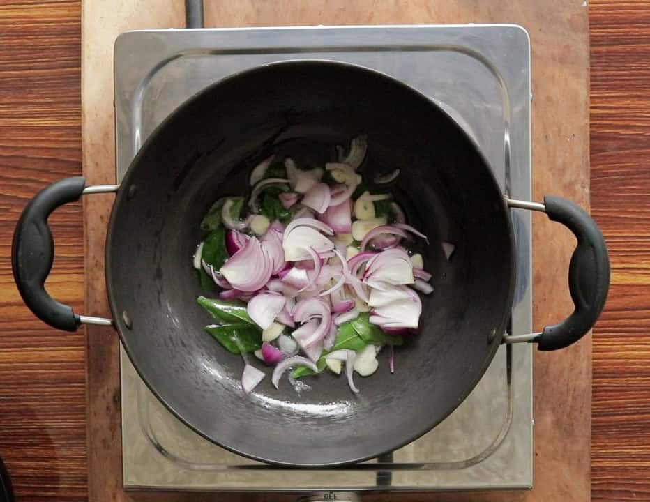 tempering onions, garlic and curry leaves in oil for pumpkin oil.