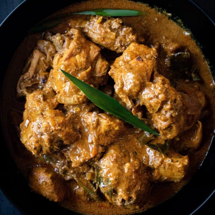 a bowl of chicken curry placed on a table.