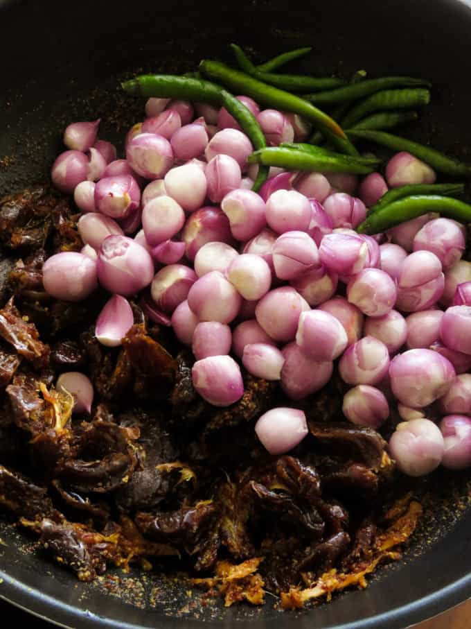 adding the onions,dates, and green chillies to the malay achchaaru.