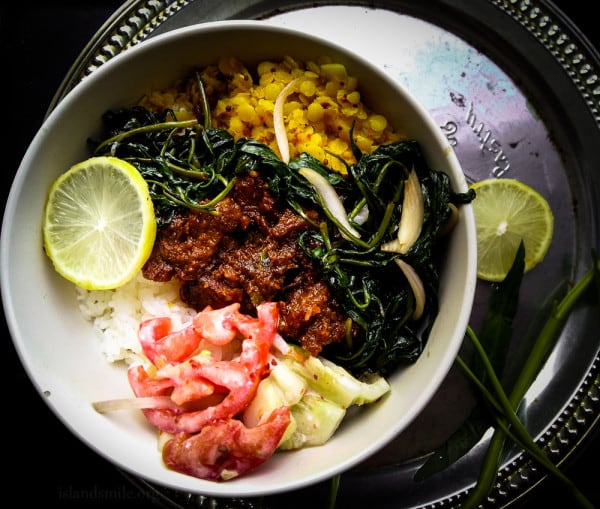 dhal,beef rendang, tomato salad, kangkung stir fry , meal in a bowl . find recipe on www.islandsmile.org