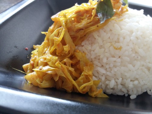 rice, a tangy paprika salad, beans and carrots cooked in coconut milk, cabbage stir fry and a crispy pepper beef curry.