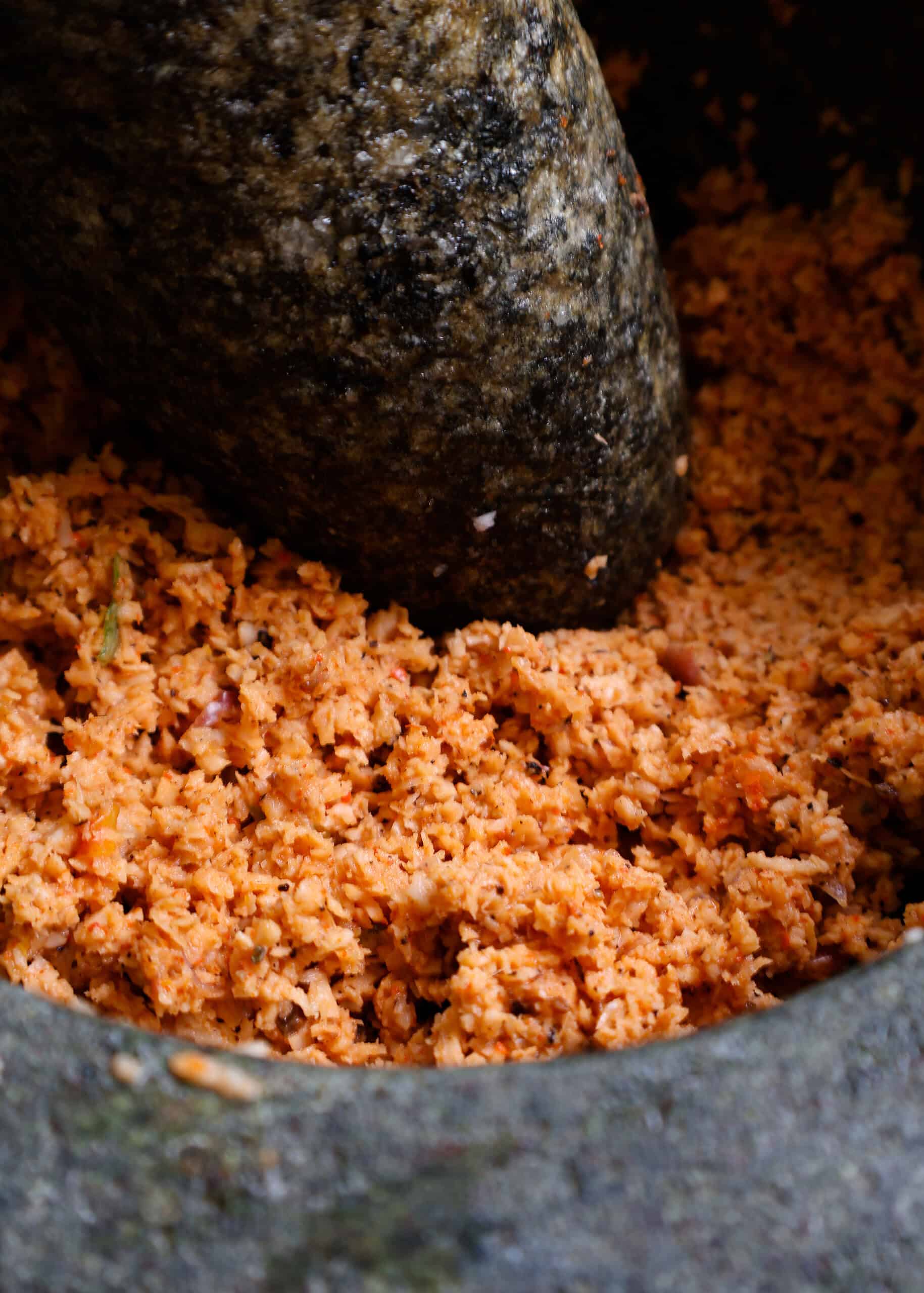 pol sambol or coconut sambol inside a mortar and pestle.