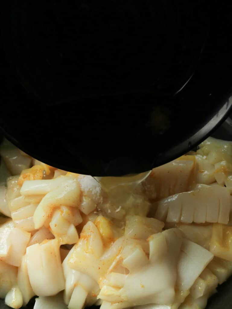 adding egg white to the hot butter cuttlefish to make the crispy hot butter cuttlefish recipe.