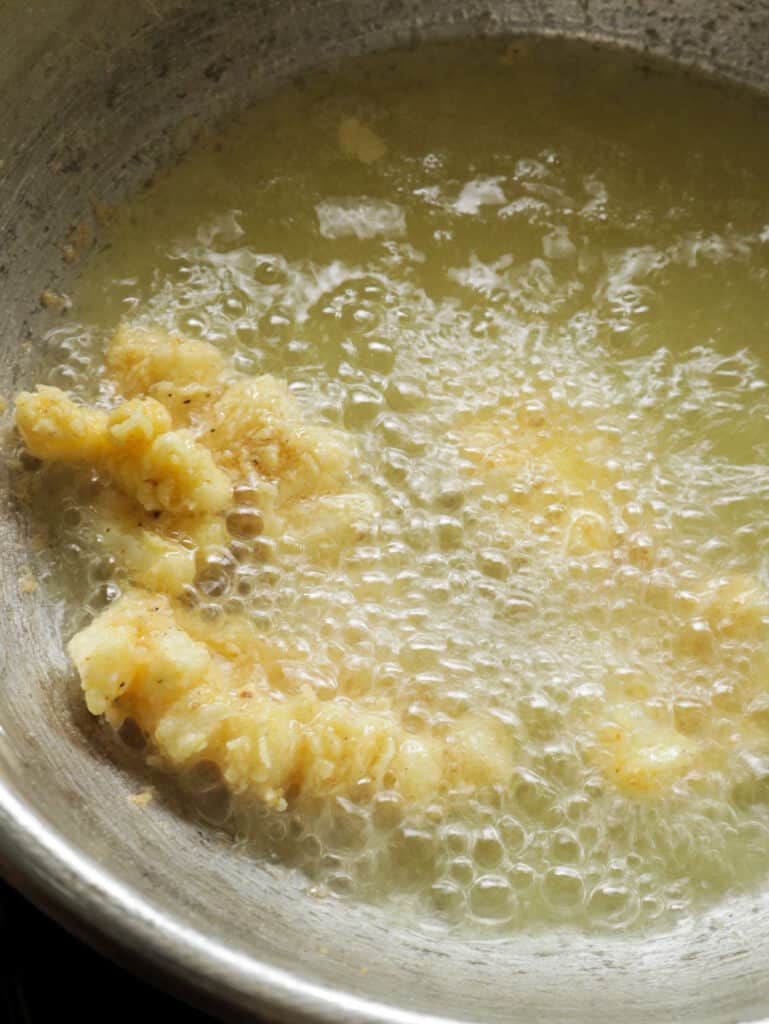 frying th cuttlefish until crispy and golden brown.