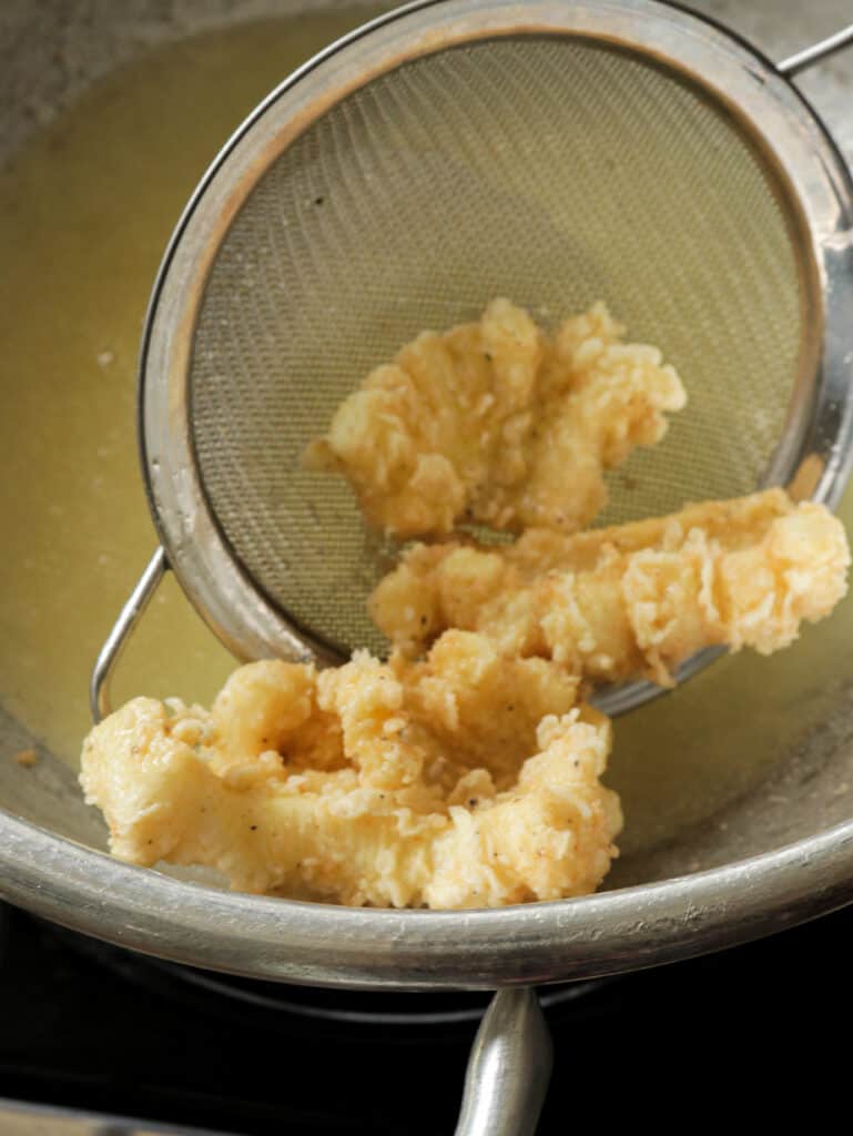 frying th cuttlefish until crispy and golden brown.