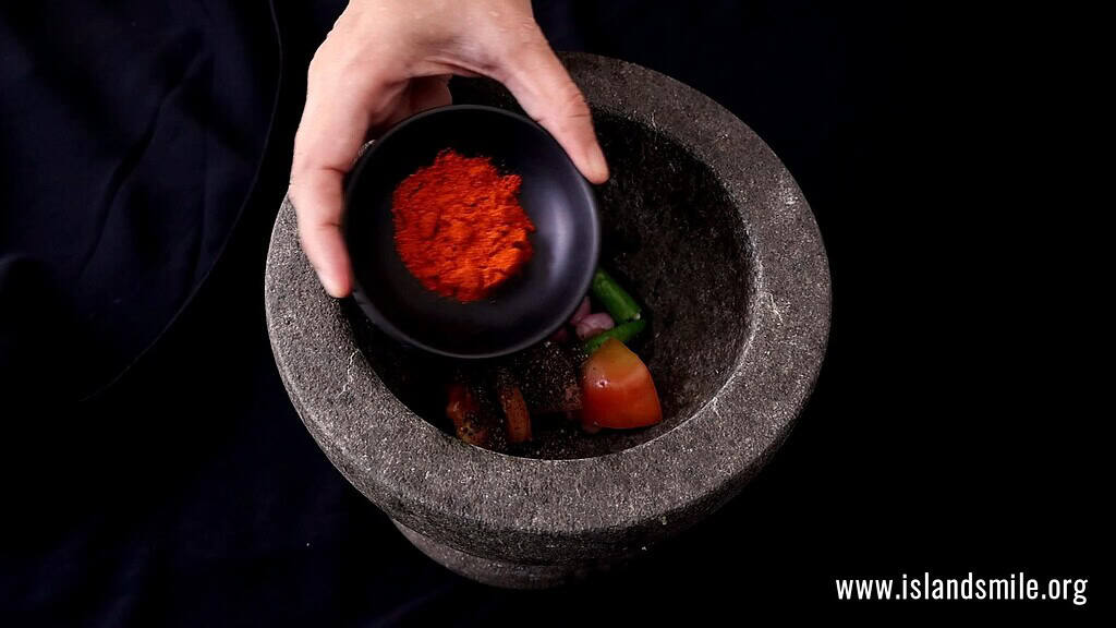 adding half of the red chilli powder tp make the coconut sambol.