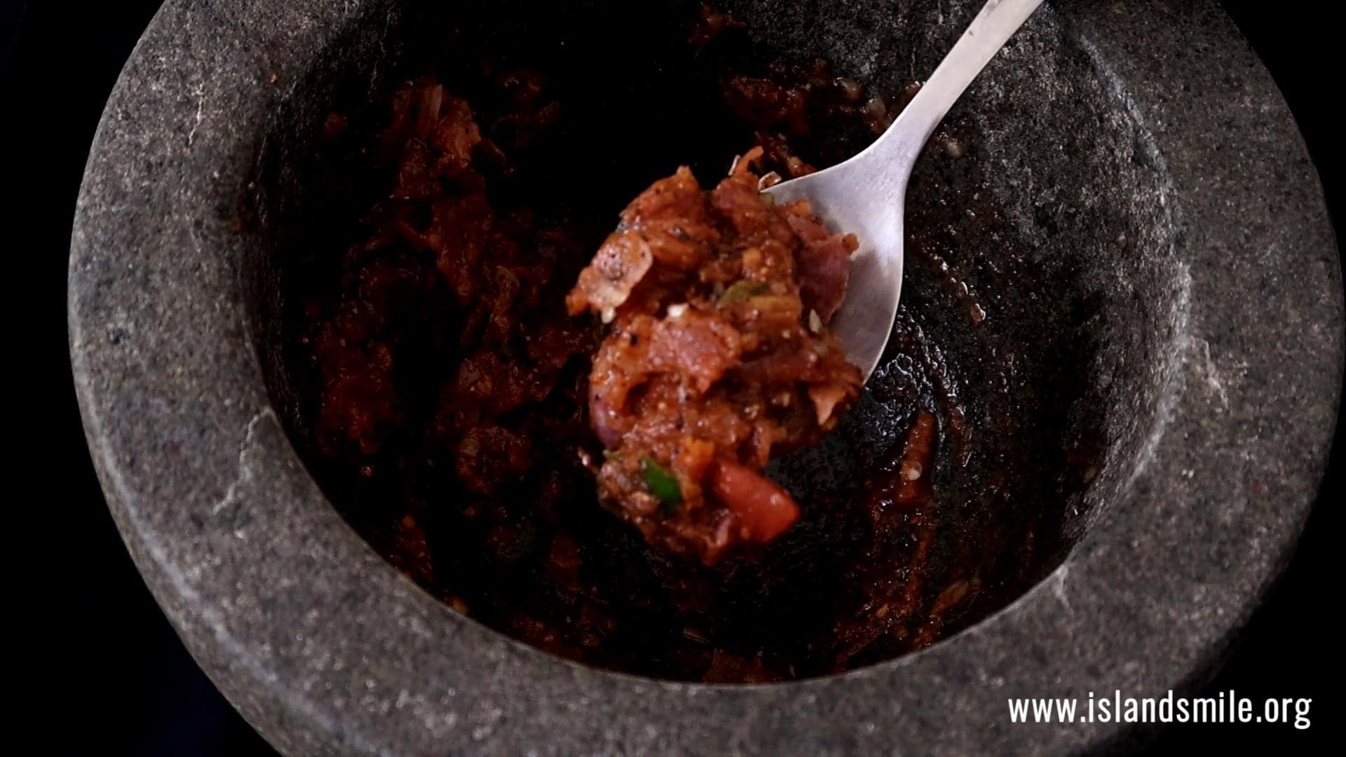 pounding all the ingredients in the mortar.