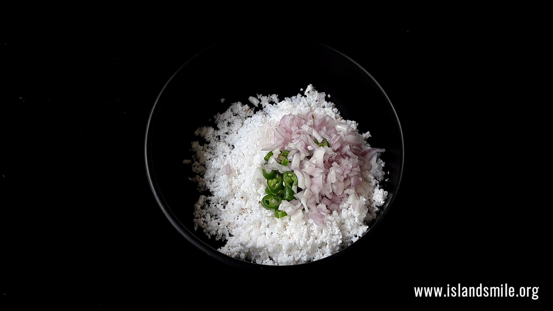 adding the scraped coconut, chopped onions, green chillies to the bowl.
