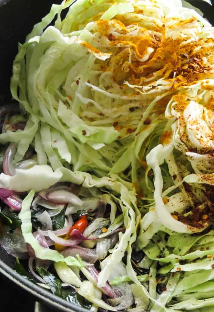 cooking the cabbage fry with onions and curry leaves.