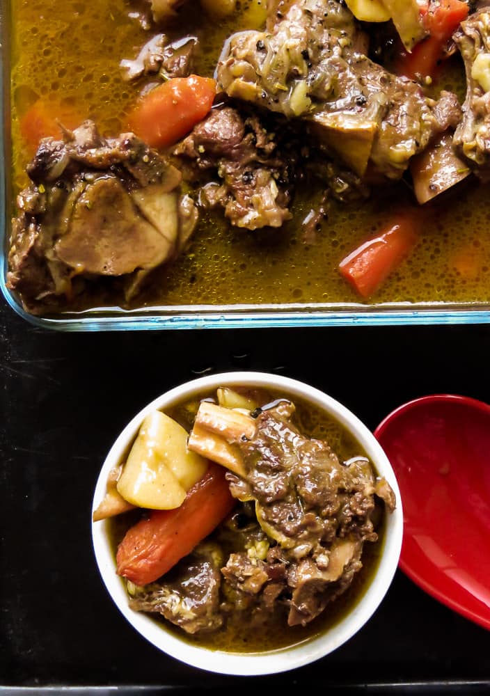 a bowl of beef and vegetable broth based soup.