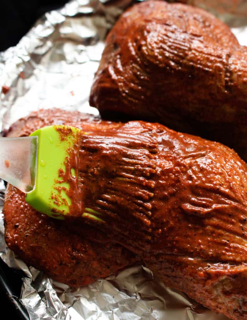 baked tandoori chicken quarters placed in foil