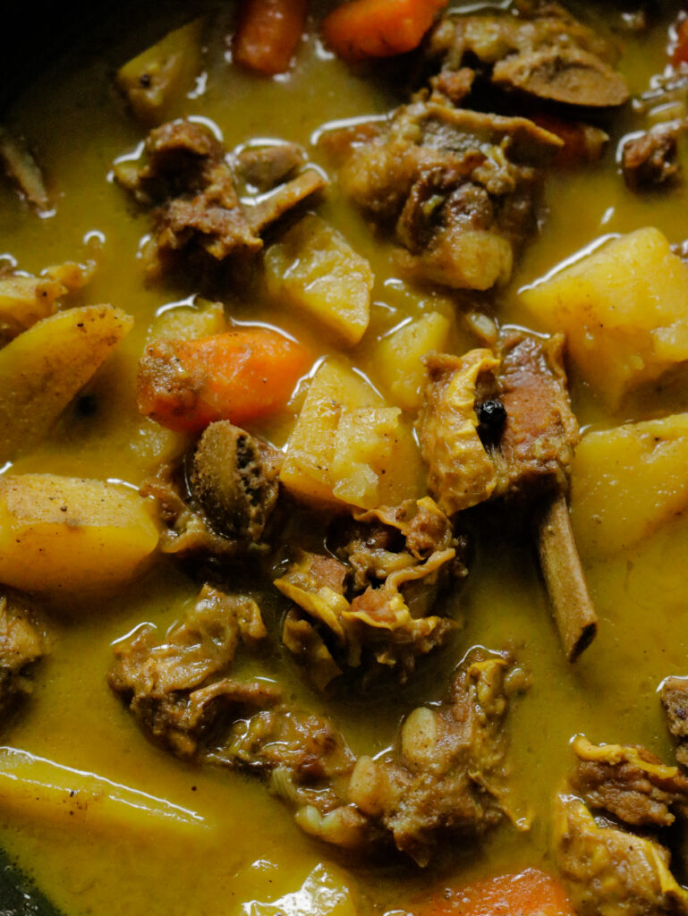 chunks of beef bone with carrots and vegetables.