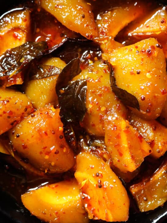 sweet and spicy mango served in a black bowl.