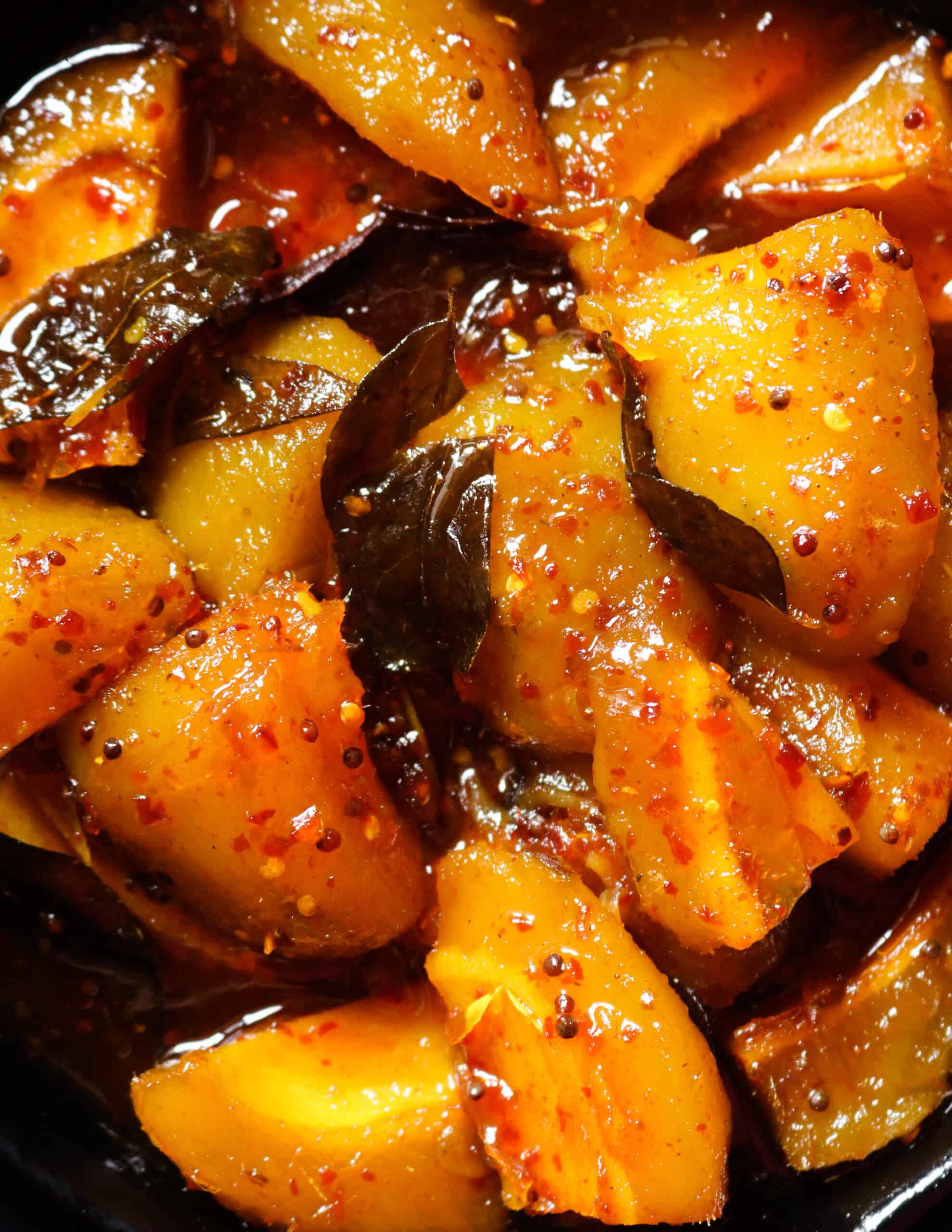 sweet and spicy mango served in a black bowl.