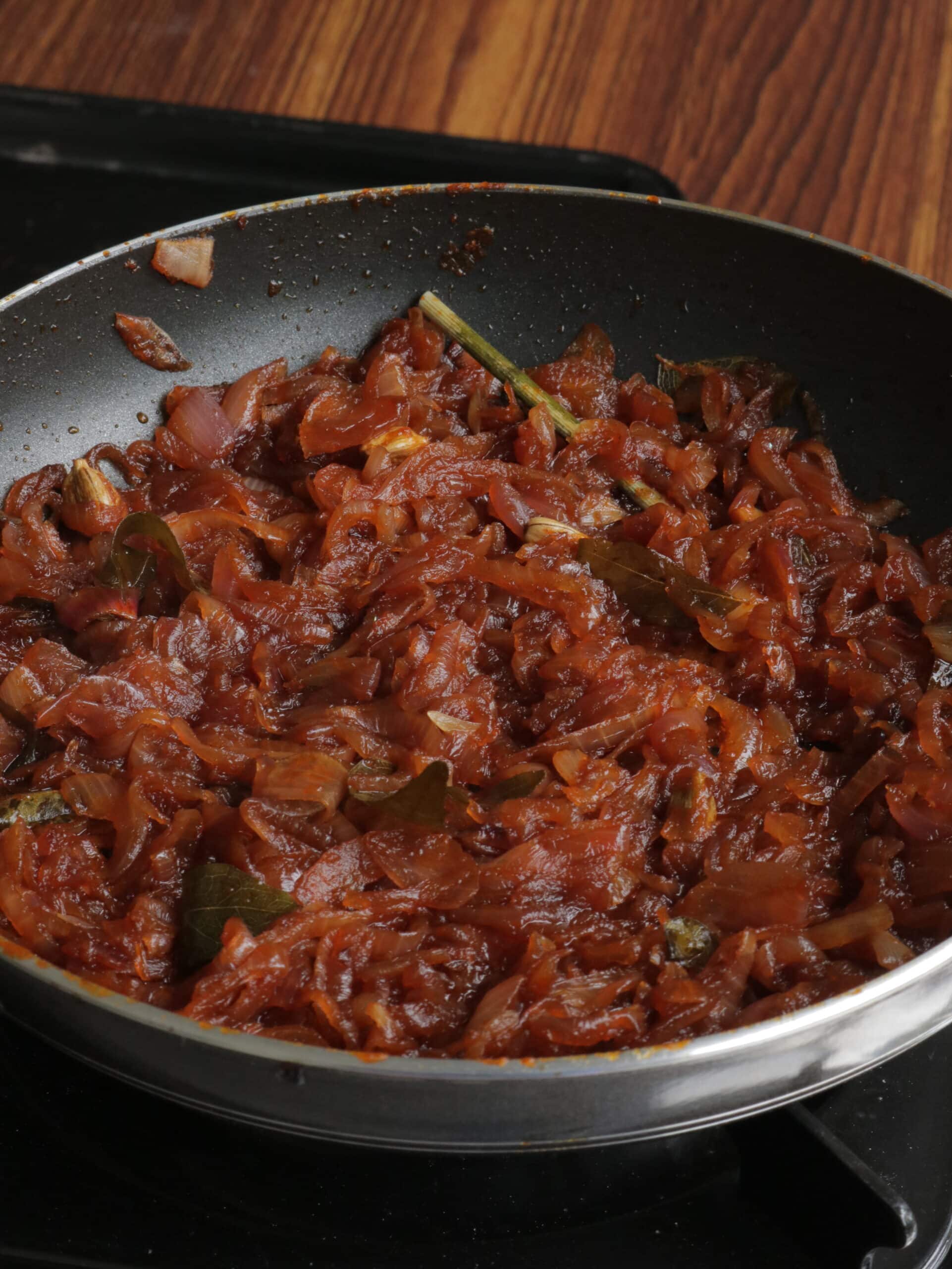 seeni sambol cooked in a frying pan with aromatic spices.