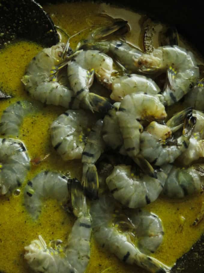 adding the cleaned prawns to the pepper sauce to make the pepper prawns(shrimp) curry.