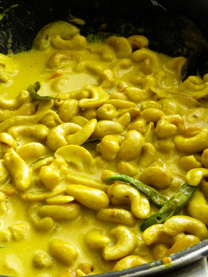 cashew curry cooked in coconut milk with curry leaves and pandan leaves.