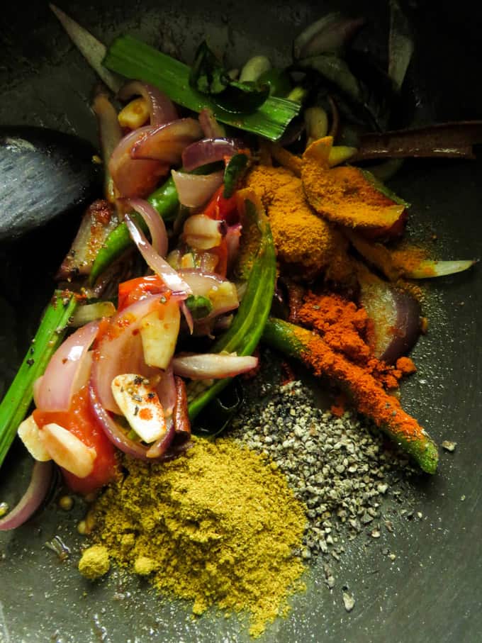 ingredients tempered for canned sri lankan fish curry.