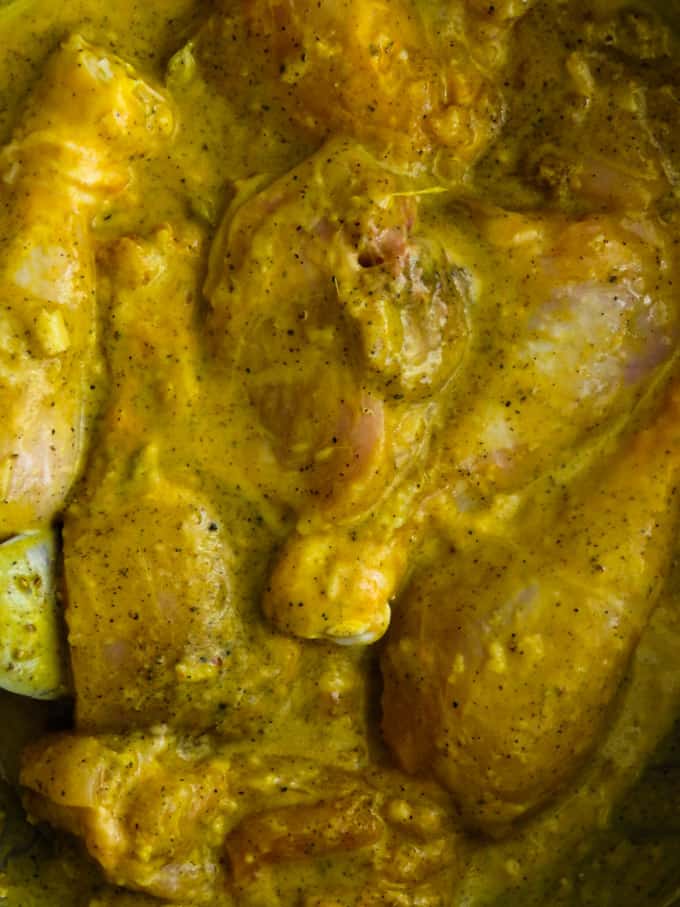 mix and combine the yoghurt spice marinade in the chicken.