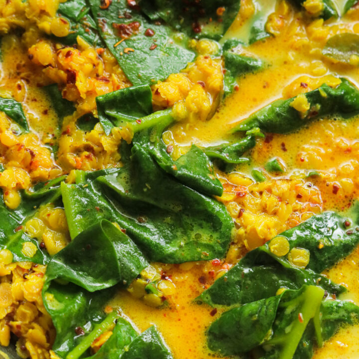 spinach and dal curry cooked in a pan.