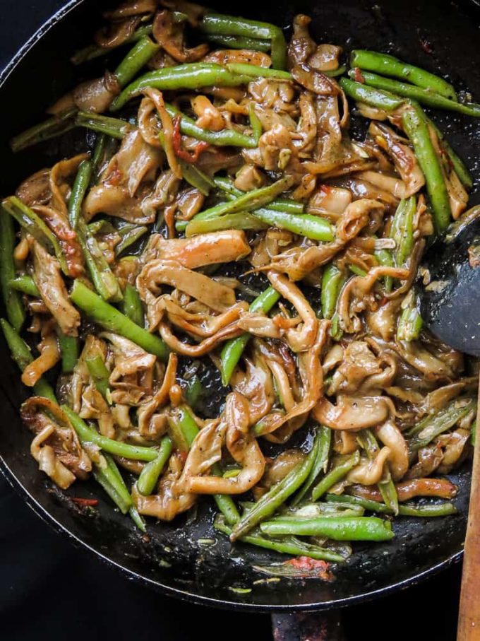 oyster mushroom and green bean stir-fry in a frying pan.