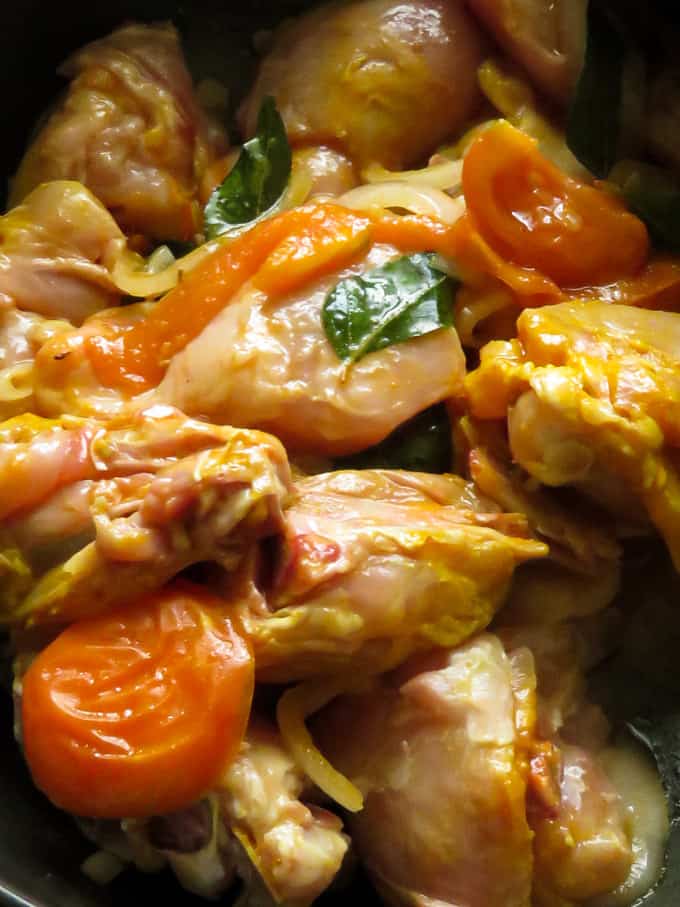 add the chicken parts to the onions and tomatoes cooking in the pan.