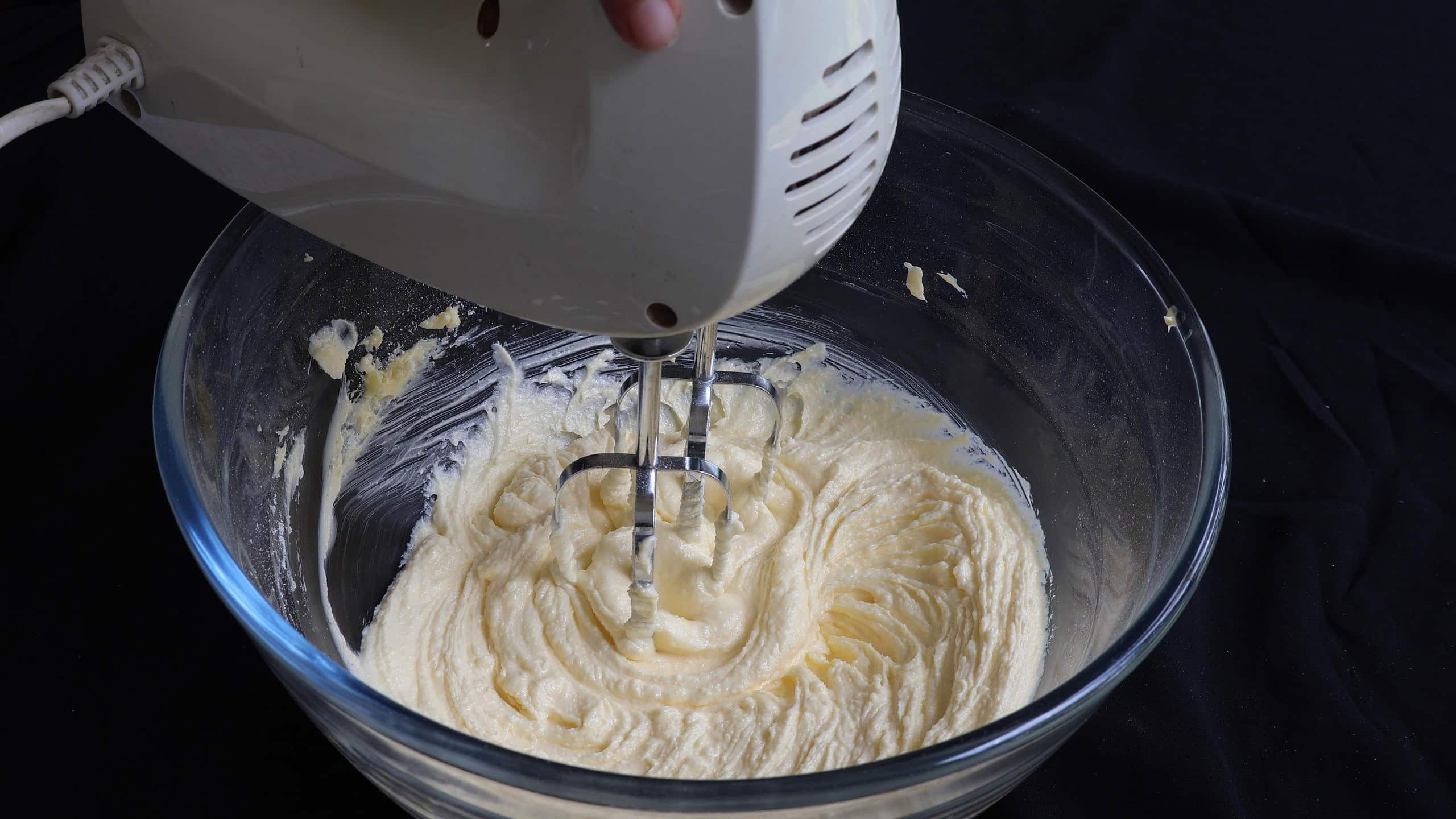 creaming the sugar and the butter to make the butter cake.