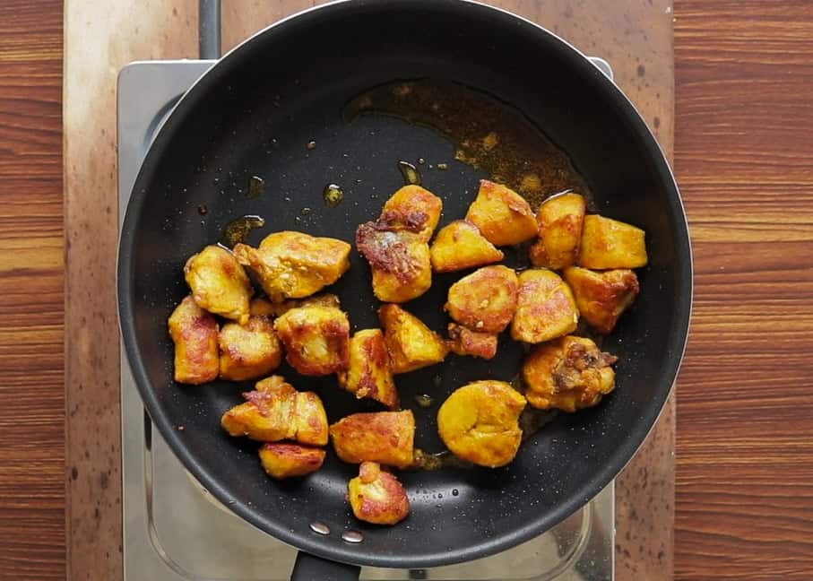 frying the chicken in oil to make devilled chicken.