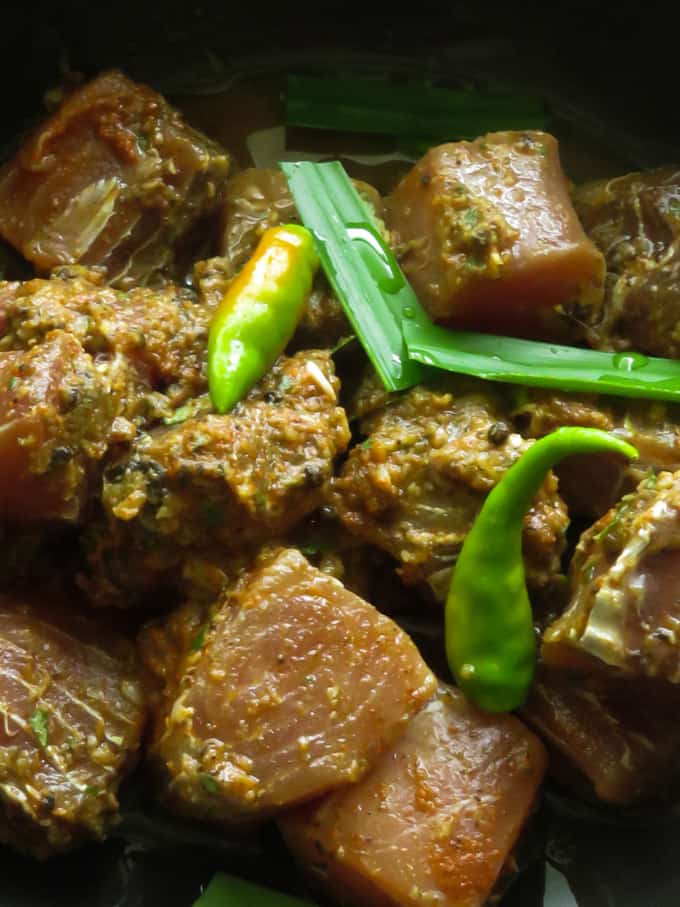 Adding extra chillies pandan leaf to the fish curry.