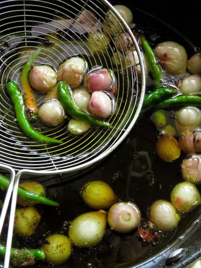 frying shallots and green chillies for brinjal moju.