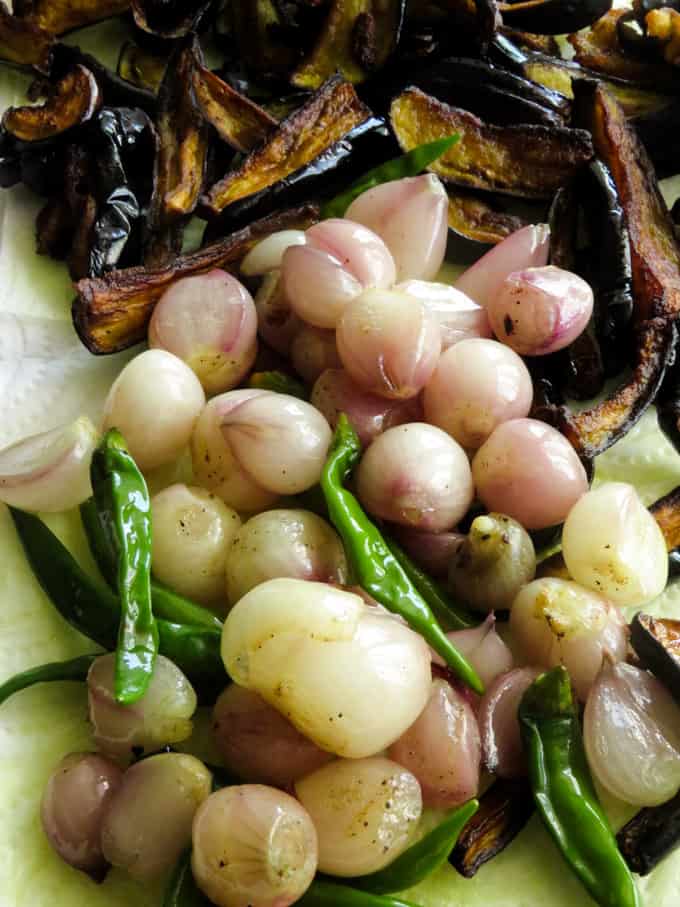 fried brinjal strips, shallots and green chillies for Sri lankan eggplant salad.