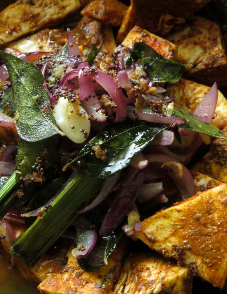 adding the tempered ingredients to the marinating cubed baby jackfruit pieces.