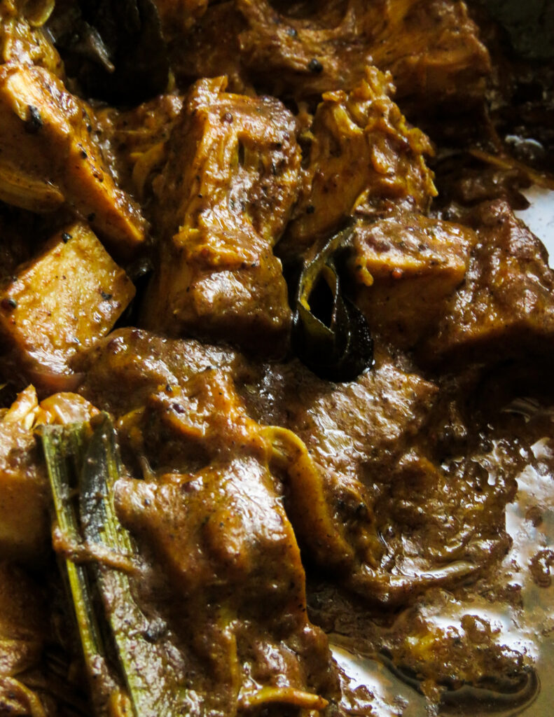 thick baby jackfruit curry with curry leaves and pandan leaves.