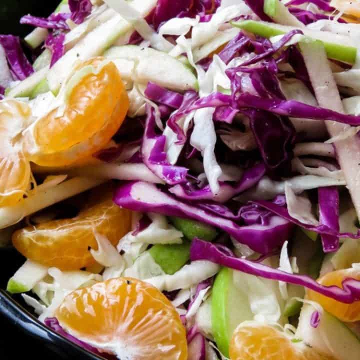 Raw cabbage and apple coleslaw- a crunchy vegan, vegetarian, gluten-free, easy salad that's not only healthy but makes a lovely colorful healthy addition to your table. my kids loved it and hopefully, yours will too.