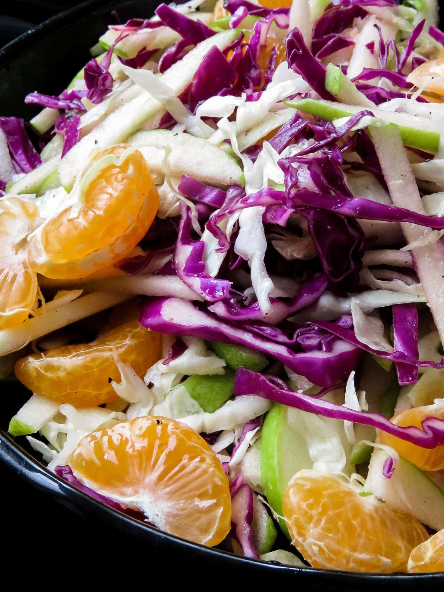 Raw cabbage and apple coleslaw with orange-honey vinaigrette- a crunchy vegan, vegetarian, gluten-free, easy salad that's not only healthy but makes a lovely colorful addition to your table. my kids loved it and hopefully, yours will too.