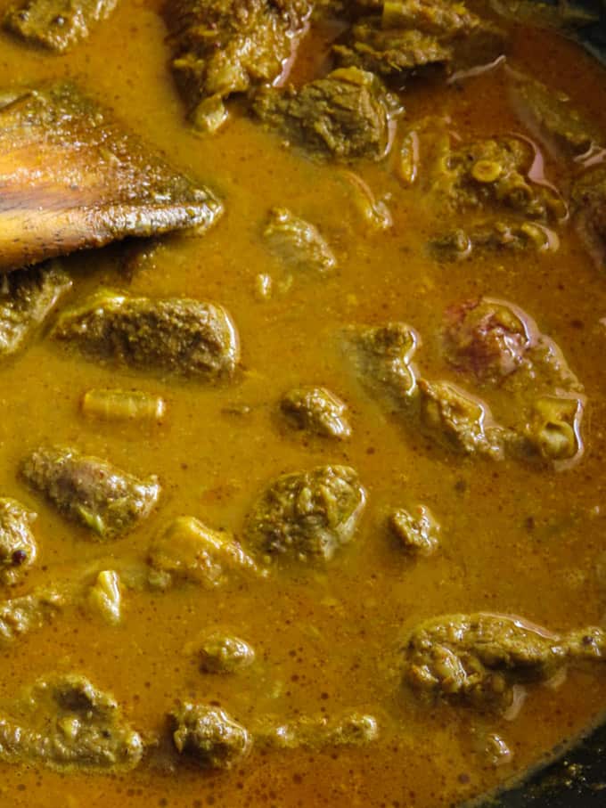 cooking the beef and potato curry in water.