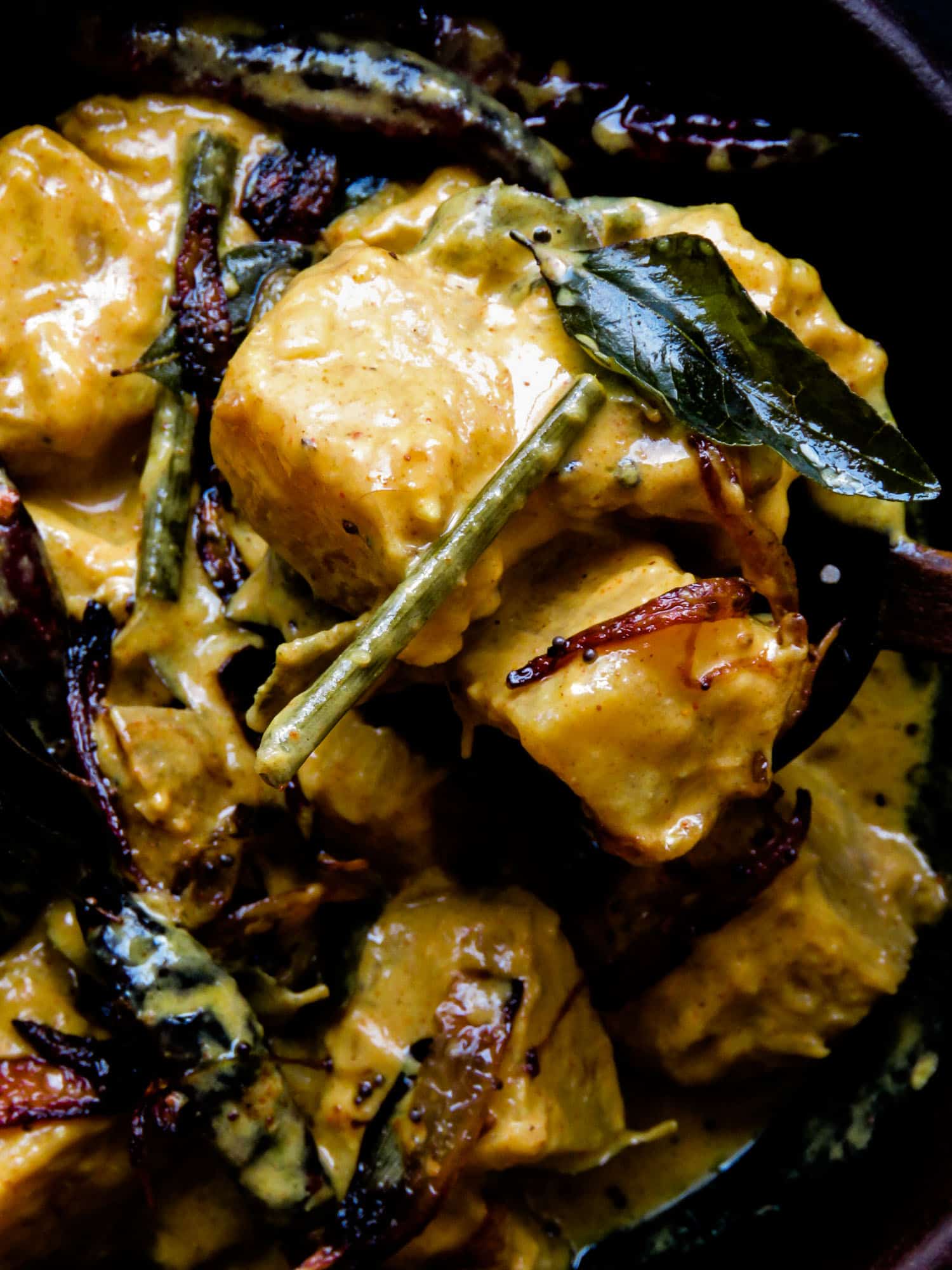 Sri Lankan breadfruit curry garnished with curry leaves and onions.