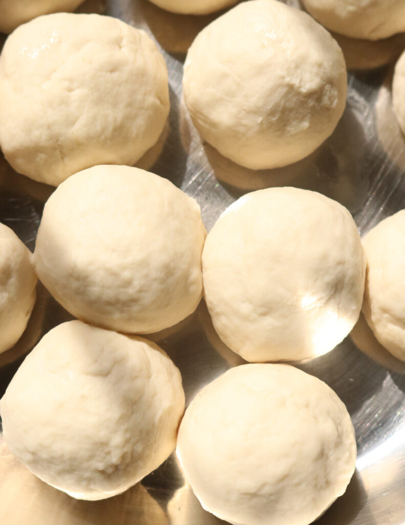 separating the dough into small balls to make paratha/godamba roti