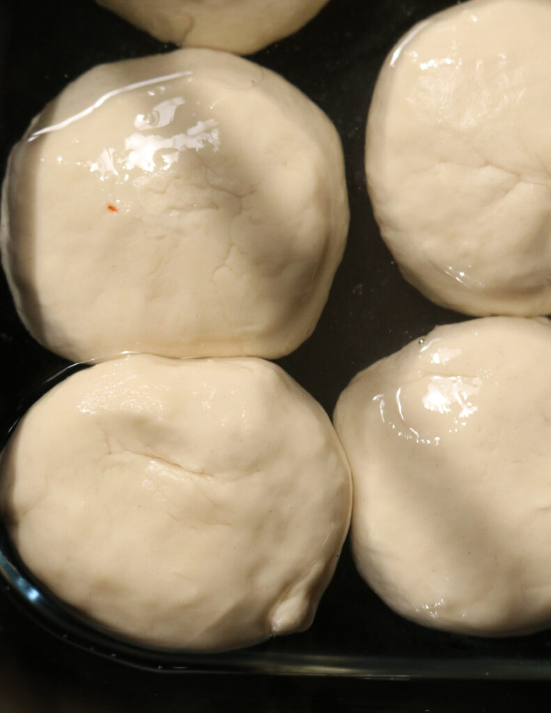 soaking the dough in oil to make paratha/godamba roti