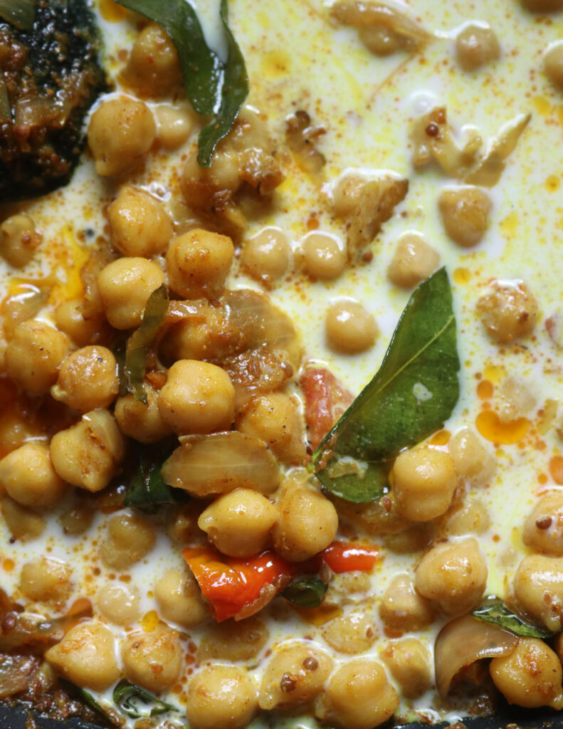 chickpea with spices and curry leaves with coonut milk added .