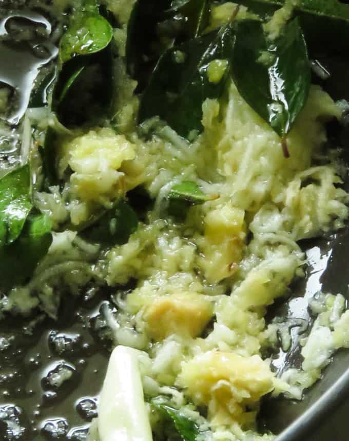 tempering ginger-garlic, curry leaves, onions to make the beef curry.