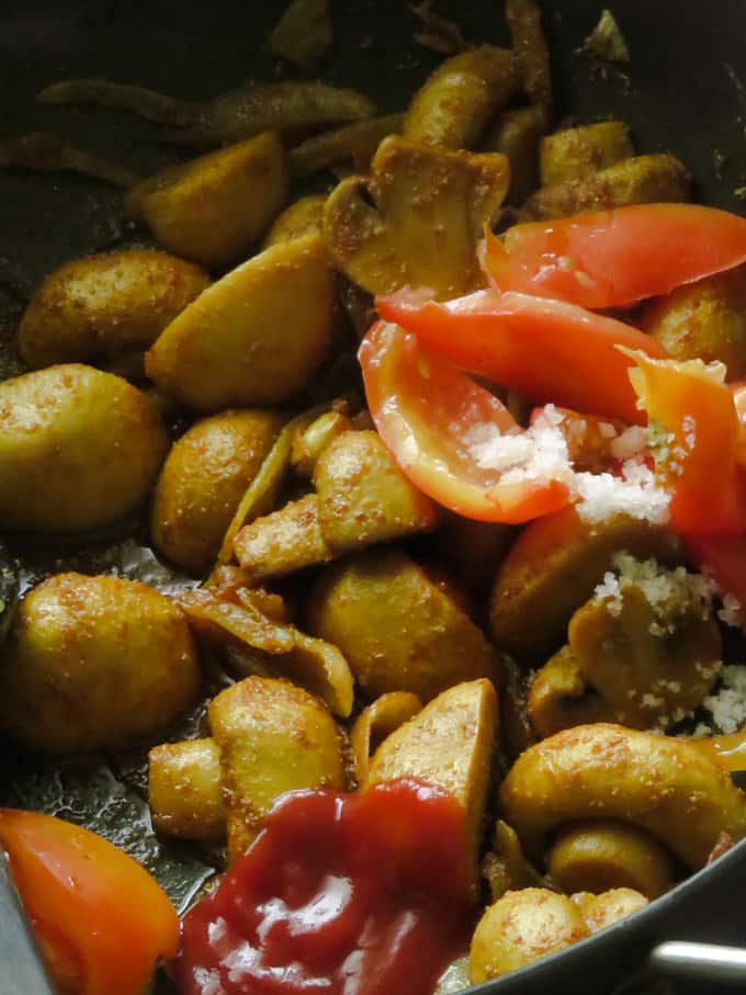 browning the mushrooms with curry spices.